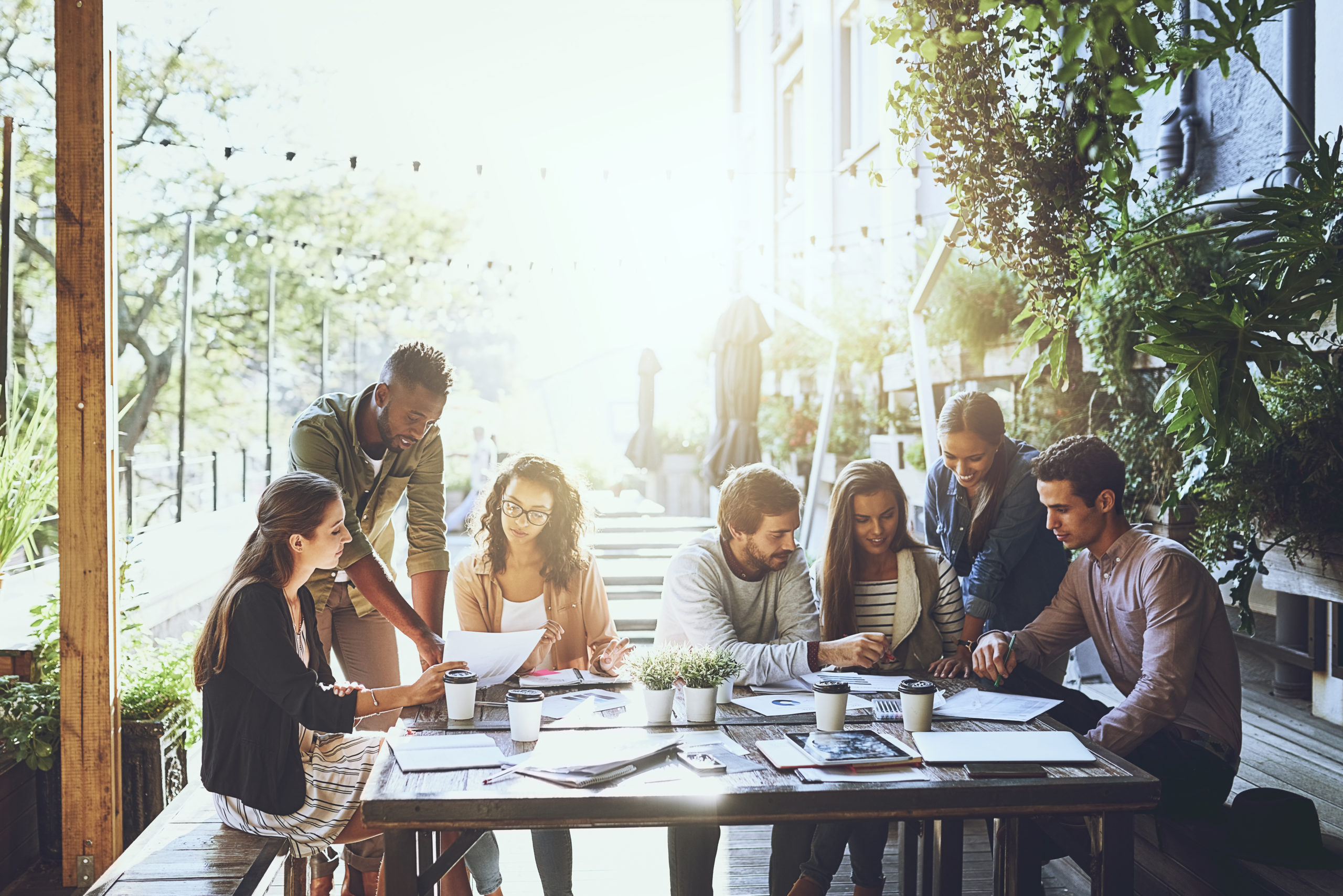 Improving productivity with a change of scenery. Shot of a group of colleagues having a meeting at a cafe.