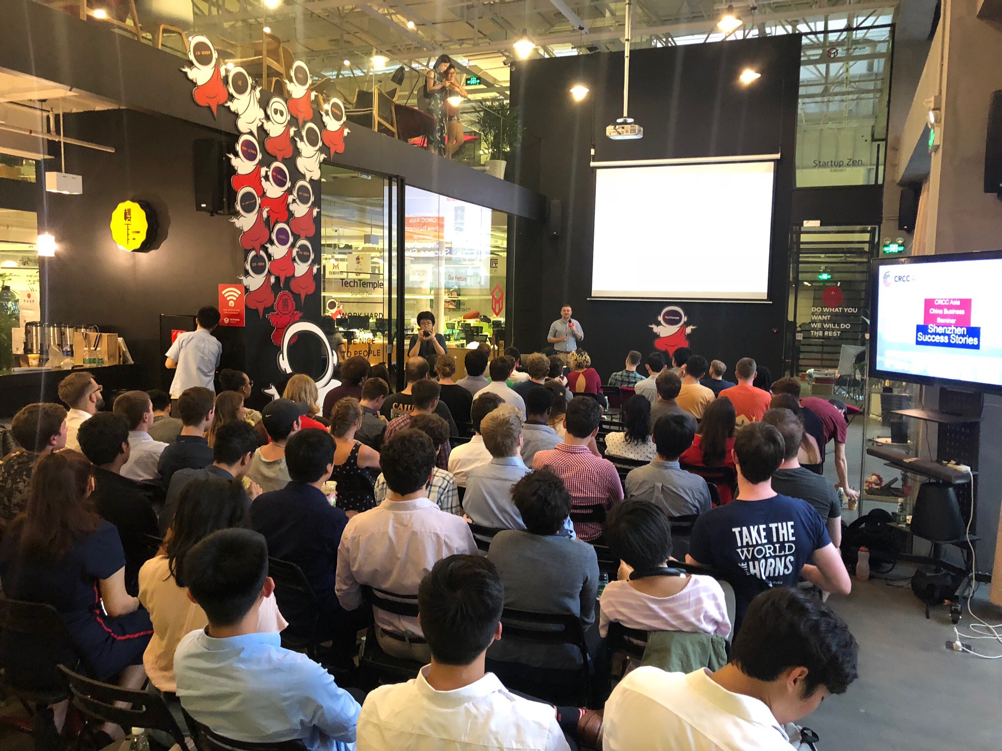 an audience of partner interns watch a seminar in shenzhen