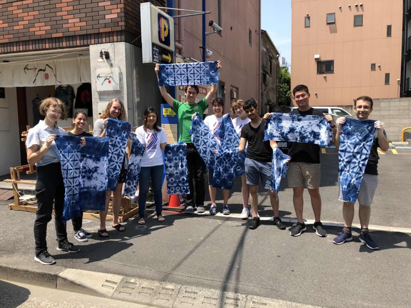 partner interns hold up japanese tie dyed cloths