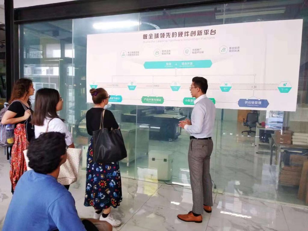 interns look at a wall chart during a company visit