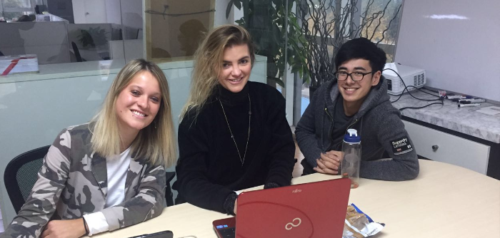 three interns with laptops